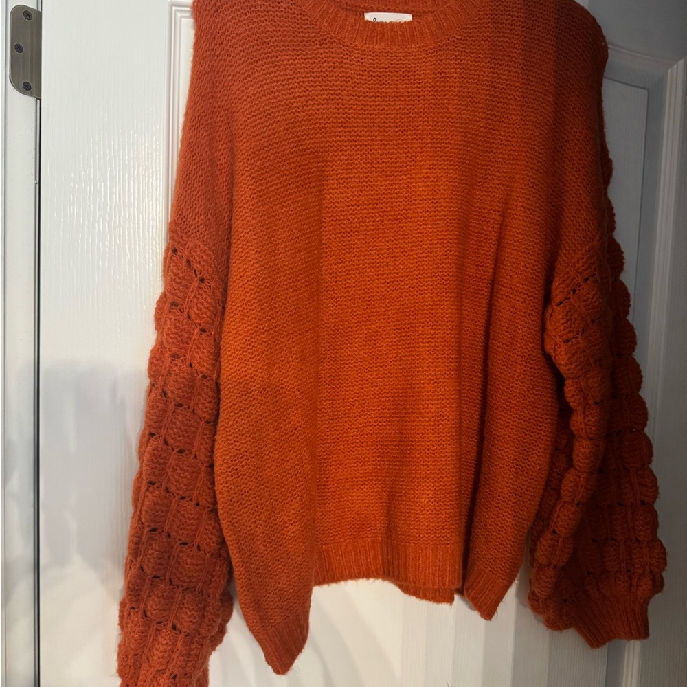 Cozy Orange Knit Sweater with Textured Sleeves